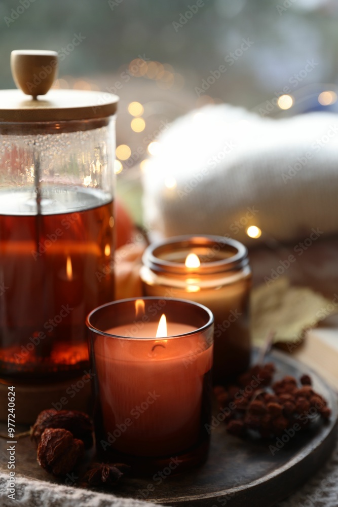 Canvas Prints Burning candles, freshly brewed tea and autumn decor on fabric, closeup