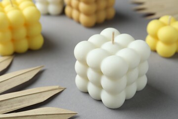 Beautiful bubble candles and decor on grey table, closeup