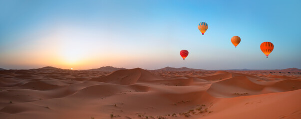 Hot air balloon flying over beautiful sand dunes in the Sahara desert - Sahara, Morocco