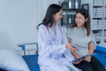 Fototapeta premium consulting female patient about pills and discussing health treatment sitting in the office at the desk. Medicine and health care concept. Doctor prescribing medicine to patient in the office.