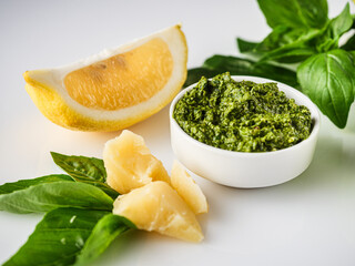 Homemade Pesto Sauce with Pine Nuts and Basil: Ingredients on White Background