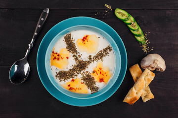 Turkish yayla soup with melted butter, herbs, and red pepper flakes