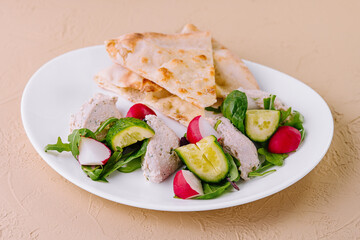 Delicious chicken pate served with pita bread and fresh vegetables on white plate