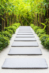 Obraz premium Peaceful stone pathway through lush green bamboo, inviting tranquility and harmony in nature.