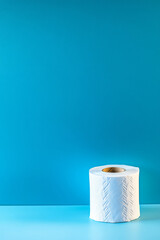 Toilet paper roll on minimalist color background with copy space