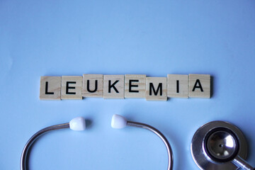 LEUKEMIA, wooden blocks with letters and stethoscope with light blue background. medicine concept