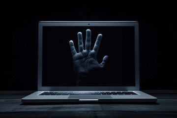 Hand Reaching Through Laptop Screen at Night