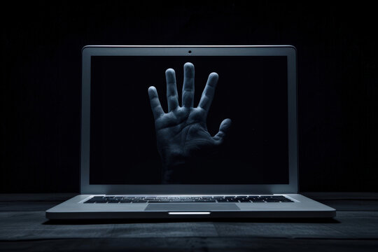 Hand Reaching Through Laptop Screen at Night