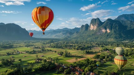 Obraz premium A hot air balloon is flying over a town and a river