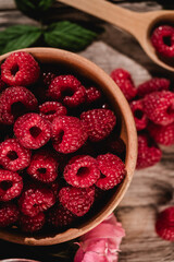 Fresh Raspberries: Juicy, Ripe Berries for a Healthy Summer Snack on a Wooden Background