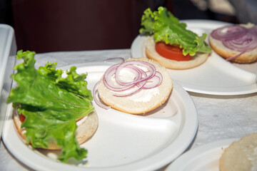 Delicious Sandwich Preparation with Fresh Lettuce, Tomato, Onion on White Plates, healthy eating concept