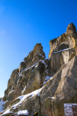 Ukrainian medieval cliff-side Tustan fortress ruins on snow in winter