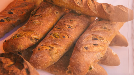 Freshly baked bread displayed on a street showcase, tempting golden crust