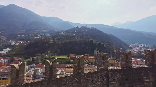 The city and Alps behind the Castelgrande wall, Bellinzona, Switzerland