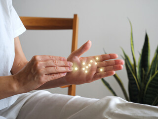 A practitioner applying reflexology to clients hand, showcasing serene atmosphere with glowing points indicating pressure points. This holistic approach promotes relaxation and well being