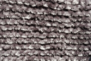 Light grey plush background made of soft velour yarn. Texture of grey pattern, close-up.