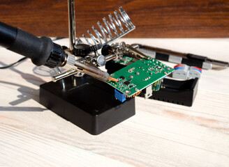 Soldering iron and lamp for illuminating the workplace.