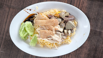 Chicken rice in a white plate on the dining table