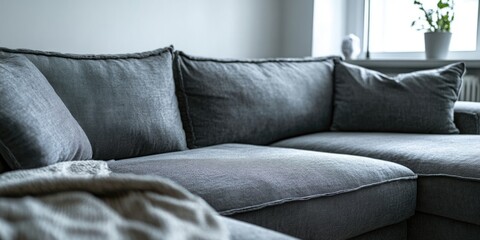 Contemporary Gray Couch with Designer Pillows and Striped Patterned Blanket