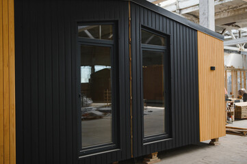 Fototapeta premium A new wooden modular prefabricated house inside in manufacturing facility