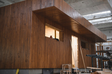 A new wooden modular prefabricated house inside in manufacturing facility