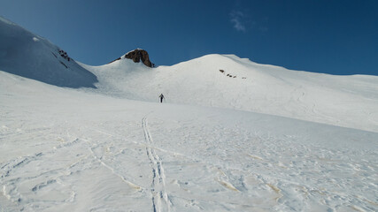 ski mountaineer climbing elgenhorn in formazza valley during winter