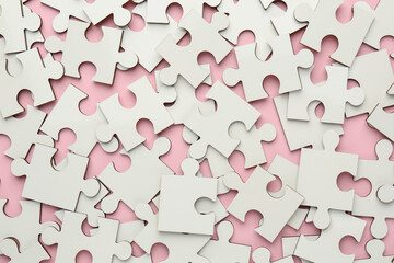 White puzzle pieces on pink background, top view