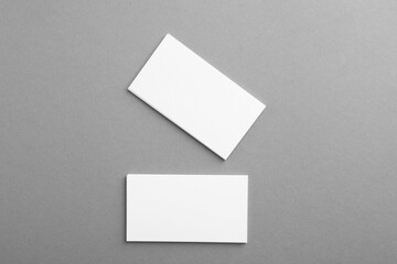 Blank business cards on grey background, top view. Mockup for design