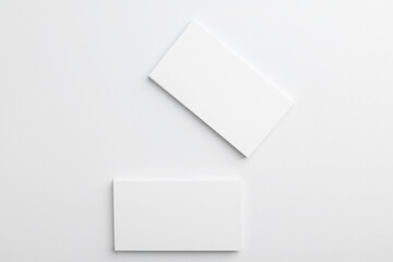 Blank business cards on light grey background, top view. Mockup for design