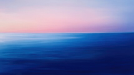Fototapeta premium A serene ocean view at twilight, featuring soft, blended colors of blue and pink reflecting on the water's surface.