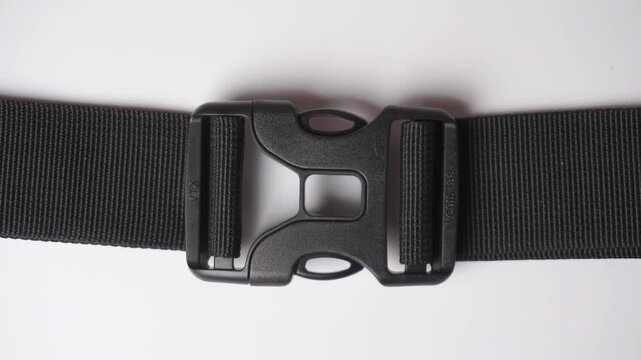 Backpack buckle. Black dual quick release buckle, closed and opened