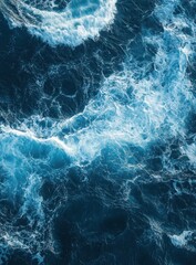 Fototapeta premium top view of ocean waves, with blue and white colors, sea foam