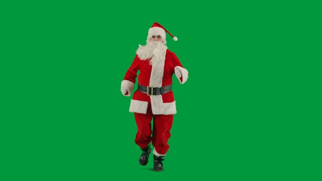 Portrait of man dressed as Santa on chroma key green screen background. Santa Claus in red outfit with beard and mustache running. - Powered by Adobe