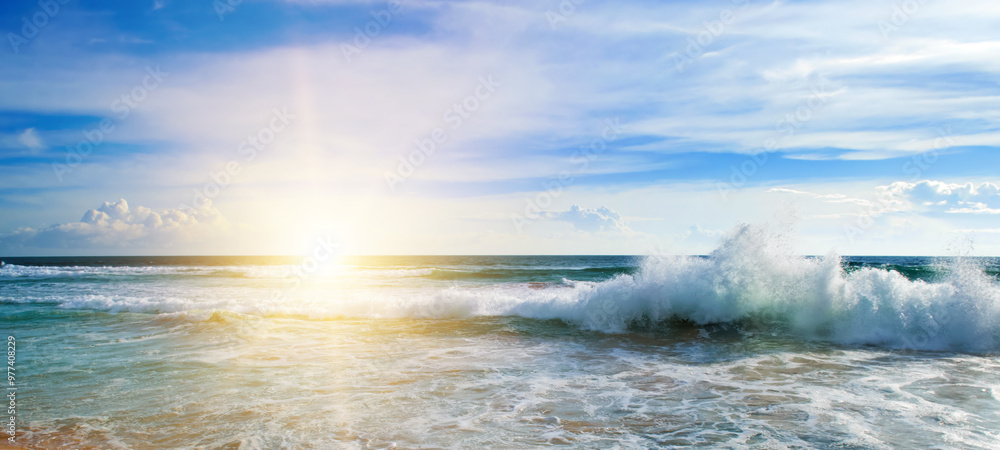 Poster Sea and bright sun on blue cloudy sky.