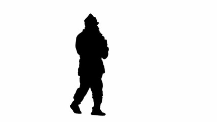 Christmas and New Year holidays concept. Black silhouette of a man in a Santa Claus costume on a white isolated background. Santa Claus walks with a stack of gift boxes. Half turn.