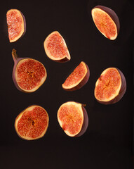 Sliced ​​figs hanging in space on a black background