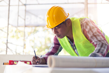 Asian architecture designing blueprint planning using pencil ruler measuring drawing, working in...