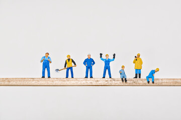 various workers high on a wooden beam