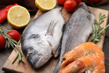 Fresh raw sea food and products on wooden table, closeup