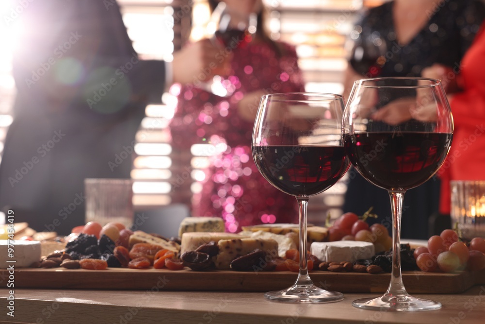 Canvas Prints People holding glasses of wine at party, focus on wooden table with snacks and alcohol