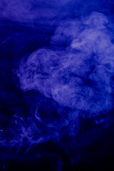 Volutes de fumée flottant sur un fond noir.