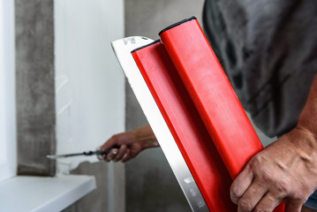 Close up of putty knife or spatula for plastering walls with finishing putty.