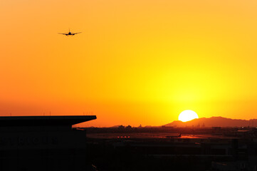 A commercial airliner descends toward Sky Harbor International Airport in Phoenix, Arizona, as the...