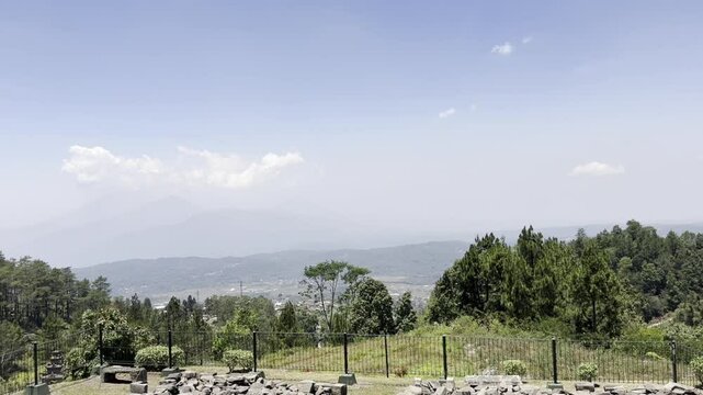 A view of the forest and clear sky in the middle of a tourist attraction.