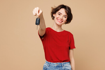 Young smiling happy woman she wear red t-shirt casual clothes hold in hand car key fob keyless...