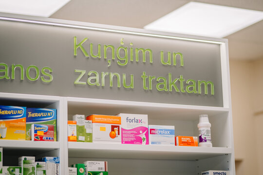 Ilukste, Latvia - September 10, 2024 - Pharmacy shelf with digestive health products and medicines displayed under a Latvian sign.