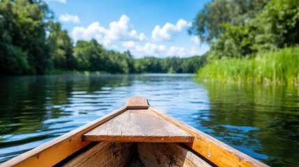A close-up view from the bow of a wooden boat navigating a peaceful river, surrounded by lush greenery and serene water, representing adventure, tranquility, and nature.