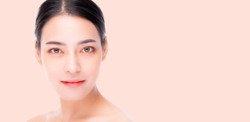 Fototapeta premium A close-up portrait of a woman with flawless skin, showcasing natural beauty and a soft, serene expression. The bright, minimalist background highlights her radiant complexion and calm demeanor.