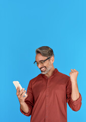 Happy middle aged business man, excited mature professional businessman winner investor holding...