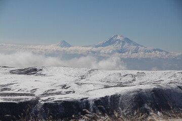 Majestic snow-capped mountain range under clear blue sky, a breathtaking winter wonderland